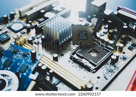 Selective focus computer chip on socket. Chipset on electronic circuit board of PC motherboard at repair workshop. CPU chip. Electronic components. Computer hardware. Upgrade computer processor chip.