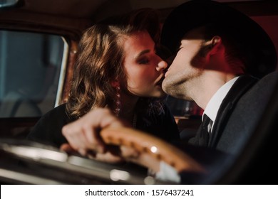 selective focus of couple kissing in retro car 