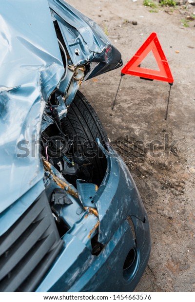 selective\
focus of crashed blue car after car accident\
