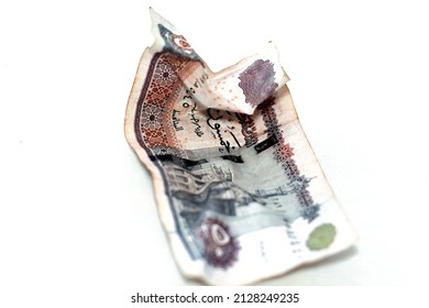 Selective focus of crumpled Egyptian money of 50 LE fifty pounds isolated on white background, wrinkled 50 pounds cash bill banknote, economy inflation concept