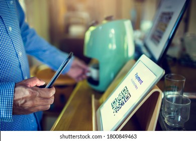 Selective Focus To Customer Using Smart Phone Scan QR Code On Tablet To Payment At Counter Bar In Coffee Shop. Accepted Generate Digital Pay Without Money.