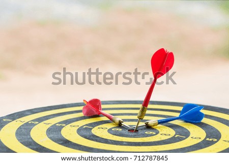 Selective focus dart hitting in target center of dartboard ,competitive business concept,organization that has potential to be lead the business.