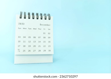 Selective focus of December 2023 desk calendar on blue background with copy space. - Shutterstock ID 2362710297
