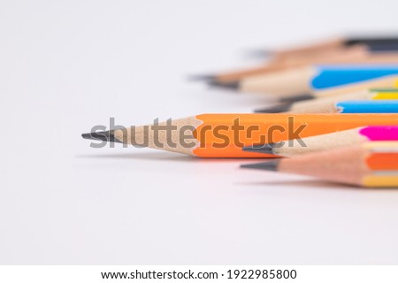Selective focus  different muticolored pencils on white background.Difference concept.