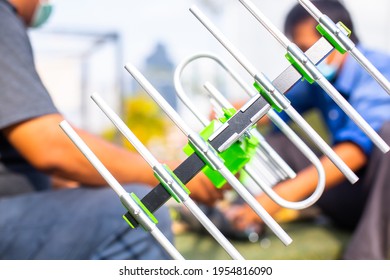 Selective Focus To The Digital TV Antenna With The Hands Of A Technician Is Installing.