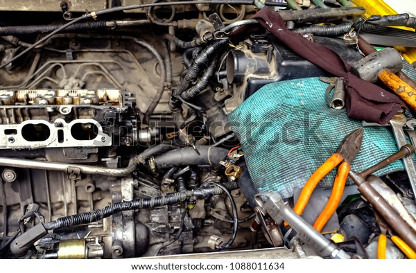 Selective focus at dirty car engine and dirty tools .\
Repair car engine and fixing a car. concept of service and car\
maintenance 