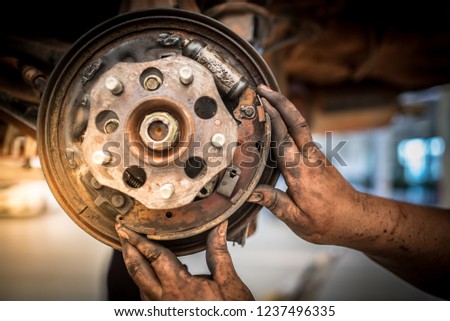Selective focus disc brake on car, in process of new tire replacement,Car brake repairing in garage