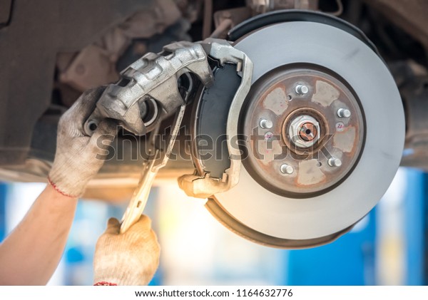 Selective focus disc brake on\
car, in process of new tire replacement,Car brake repairing in\
garage