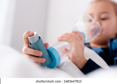 Selective Focus Of Diseased Kid Using Inhaler With Spacer