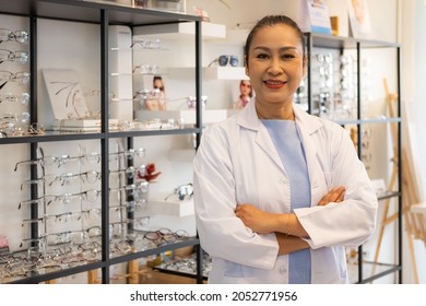 Selective focus at the doctor or optometrist who specialize with eyeglasses diagnostic and examination, standing inside of the optical shop. Eye care with professional consulting.