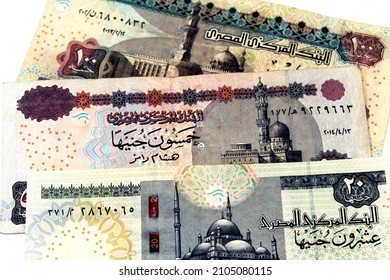 selective focus of Egyptian money currency banknotes bills isolated on white background of twenty pounds 20 LE , fifty 50 LE and one hundred pounds 100 LE, money background exchange rates concept