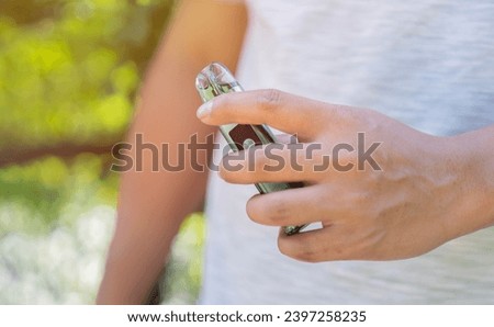 Selective focus of an electronic cigarette in man's hand, smoking and vaping negative health effects. Smoking habit,nicotine addiction.