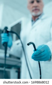 Selective focus of an endoscope in hand of a doctor stock photo