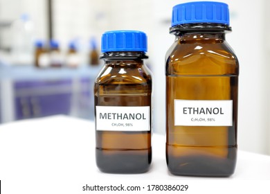 Selective focus of ethanol and methanol brown amber glass bottle inside a laboratory. Blurred background with copy space.