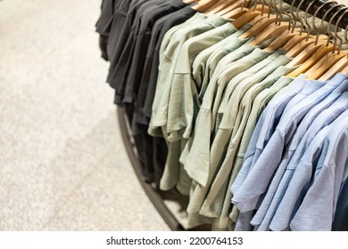 Selective Focus, Fashion , Clothes Concept ,Clothes Or Pants Many Colors Hang On A Shelf In A Designer Clothes Store. Lots Of Pastel-colored