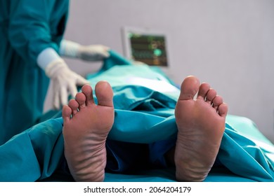 Selective Focus At Feet Of Pass Away Patient While Doctor Covering Face Inside Of The Surgery Operation Room In The Hospital. Illness And Death Concept. 