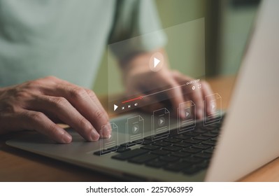Selective focus at finger that push on press play button for start online entertainment for on demand video streaming service that online over internet which include movie or music. - Shutterstock ID 2257063959