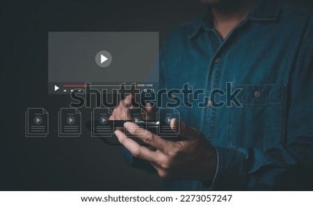 Selective focus at finger that push on press play button for start online entertainment for on demand video streaming service that online over internet which include movie or music.