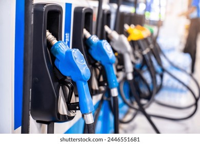 Selective focus to gas pump nozzles in a service station, Close up fuel nozzles at gas station, Panel and Dashboard of fuel nozzles of E85 E20 and Gasohol 91. The concept of fuel energy. - Powered by Shutterstock