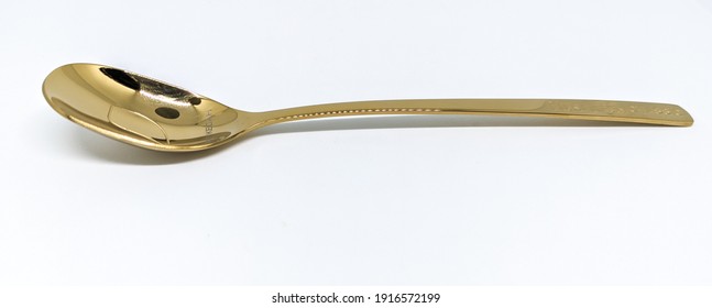 Selective Focus Of Golden Spoon Side View Isolated