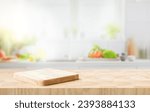 Selective focus.End grain wood counter top with cutting board on blur kitchen in morning window background.For montage product display or design key visual