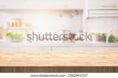 Selective focus.End grain wood counter table top on blur white cozy kitchen in morning background.For montage product display or design key visual