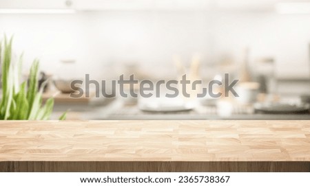 Selective focus.End grain wood counter table top on blur white cozy kitchen in morning background.For montage product display or design key visual
