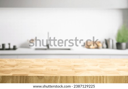Selective focus.End grain wood counter table top on blur white minimal kitchen background.For montage product display or design key visual