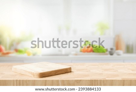 Selective focus.End grain wood counter top with cutting board on blur kitchen in morning window background.For montage product display or design key visual