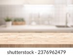 Selective focus.End grain wood counter,table top on blur kitchen counter in morning background.For montage product display or design key visual