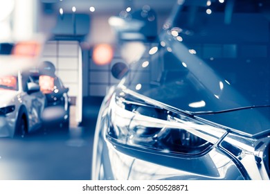 Selective focus grey car parked in luxury showroom. Car dealership office. New car parked in modern showroom. Car for sale and rent business concept. Automobile leasing and insurance background. - Shutterstock ID 2050528871