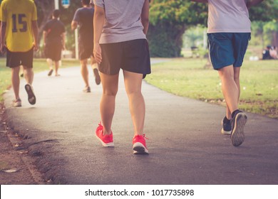 Selective focus group Of Runners Jogging Through Park,warm retro tone.