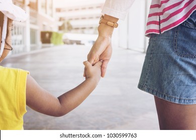 Selective Focus Hand Of Parent And Child In The Outdoor .Mother Holding Hands Little Girl