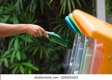 Selective Focus Hand Throwing Empty Plastic Bottle Into The Trash