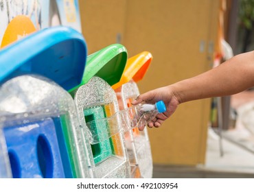 Selective Focus Hand Throwing Empty Plastic Bottle Into The Trash