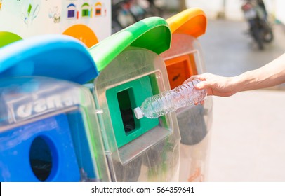 Selective Focus Hand Throwing Empty Plastic Bottle Into The Trash