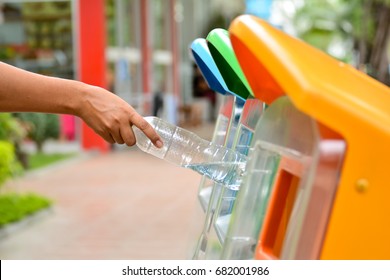 Selective Focus Hand Throwing Empty Plastic Bottle Into The Trash