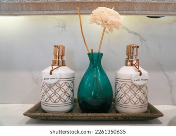 selective focus hand wash and lotion bottle on washbasin counter in luxury bedroom - Shutterstock ID 2261350635