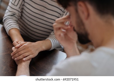 Selective focus of hands being held together