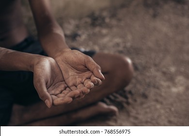 Selective Focus. Hands Poor Child Begging You For Help Concept For Poverty Or Hunger People, Human Rights,background Text.