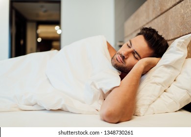 selective focus of handsome bearded man sleeping in bed 