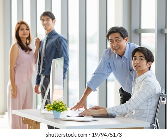 Selective Focus Handsome Business Asian Father And Son Smiling And Looking Camera Confidently And Happily While Working In Comfortable Office During The Day. Family Business And Inheritance Concept