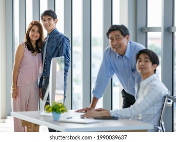 Selective Focus Handsome Business Asian Father And Son Smiling And Looking Camera Confidently And Happily While Working In Comfortable Office During The Day. Family Business And Inheritance Concept