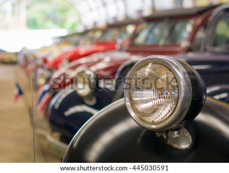 Selective focus headlight lamp vintage car in a row, copy space.