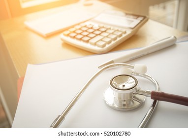 Selective Focus Health Care Costs Concept Picture : Stethoscope And Calculator On A Medical Chart ,symbol For Health Care Costs Or Medical Insurance With Effect Light Added.