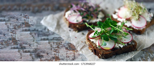 Selective focus. Healthy toasts with white cheese radish and microgreens. Keto diet. Keto toasts. Organic food. Super food.
