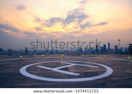 Selective focus of the Heli Copter parking lot on the deck at sunset in the capital of Thailand. Space for helicopter landing on high-rise buildings in Bangkok, Thailand.