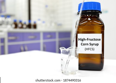 Selective focus of high-fructose corn syrup or hfcs food and beverage sweetener in dark brown glass bottle inside a laboratory. - Shutterstock ID 1874490316
