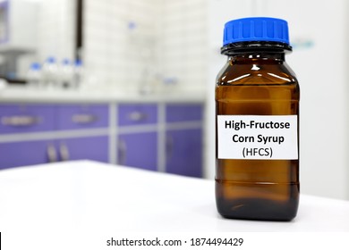 Selective Focus Of High-fructose Corn Syrup Or Hfcs Food And Beverage Sweetener In Dark Brown Glass Bottle Inside A Laboratory.