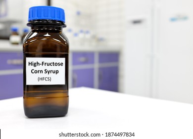 Selective focus of high-fructose corn syrup or hfcs food and beverage sweetener in dark brown glass bottle inside a laboratory. - Shutterstock ID 1874497834